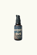A small amber glass pump bottle with a black pump dispenser and a dark label reading 'noddfa nos' and 'MADE IN WALES', centered on a plain light background.